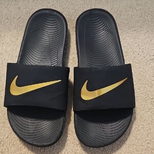 Nike Black Slides with Gold Swoosh